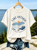Women's Casual Crewneck T-shirt In Cream With Lake Ontario Map, Sun, And Forest Print