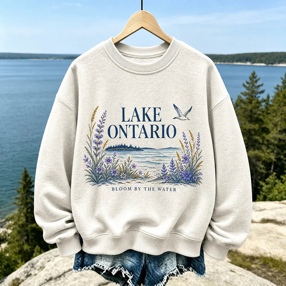 Women's Casual Crewneck Sweatshirt In Cream With Lake Ontario Water, Purple Lupine Flowers, And "bloom By The Water" Print