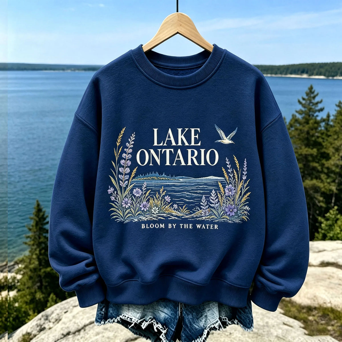 Women's Casual Crewneck Sweatshirt In Cream With Lake Ontario Water, Purple Lupine Flowers, And "bloom By The Water" Print