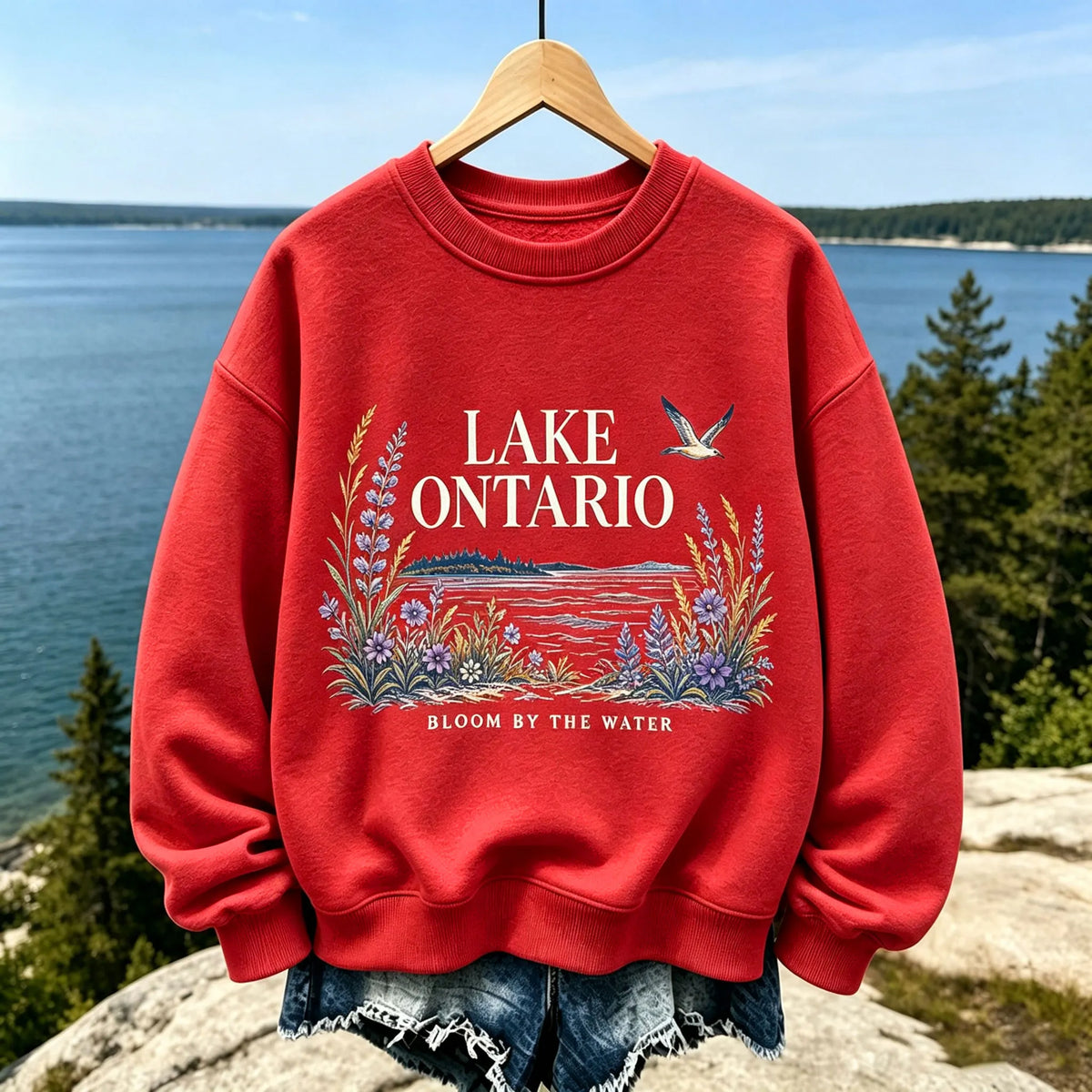 Women's Casual Crewneck Sweatshirt In Cream With Lake Ontario Water, Purple Lupine Flowers, And "bloom By The Water" Print