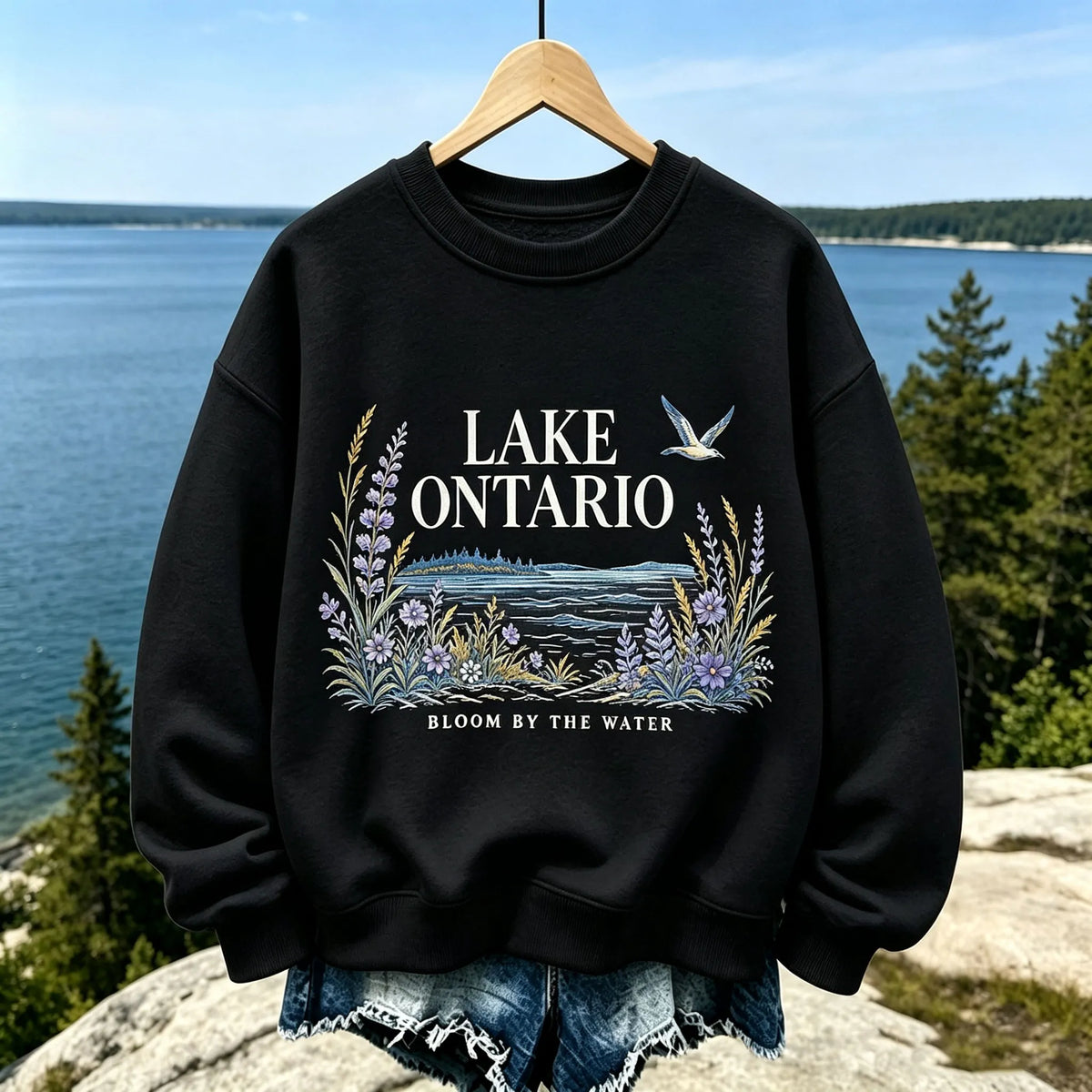Women's Casual Crewneck Sweatshirt In Cream With Lake Ontario Water, Purple Lupine Flowers, And "bloom By The Water" Print