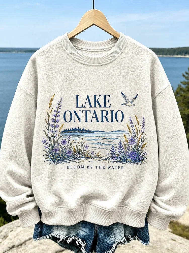 Women's Casual Crewneck Sweatshirt In Cream With Lake Ontario Water, Purple Lupine Flowers, And "bloom By The Water" Print