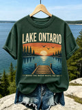 Women's Casual Crewneck T-shirt In Dark Green With Lake Ontario Sunset, Wooden Pier, And "where The Water Meets The Sky" Print